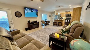 A living room with a sofa, a coffee table, a TV, and a globe. - Tranquil Foothills Retreat  (Yuma)