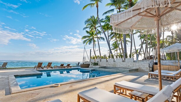 A poolside area with lounge chairs, a pool, and a view of the ocean. - Kite Beach • Oceanfront • Pool & Hot Tub 203 (Kite Beach)