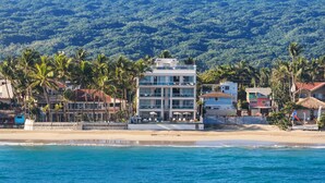 A beachfront hotel with multiple floors, a pool area, and a view of the ocean. - Kite Beach • Oceanfront • Pool & Hot Tub 203 (Kite Beach)