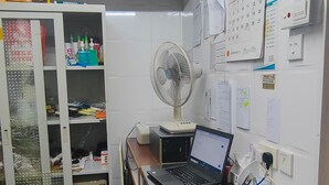 A small office with a desk, chair, and a filing cabinet. - NEW MANDARIN GUEST HOUSE (Kowloon)