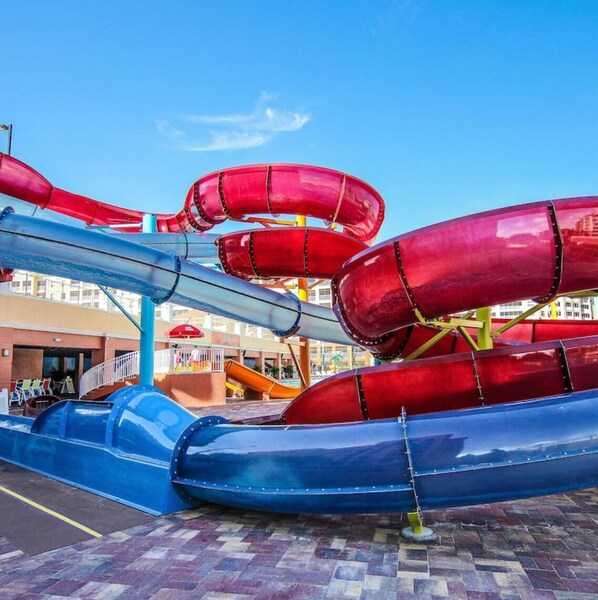A water park with multiple slides in red, blue, and orange colors. - Luxury Resort Minutes from Disney (Kissimmee)
