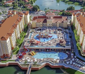A resort with a central pool, water park, and multiple hotel buildings. - Luxury Resort Minutes from Disney (Kissimmee)