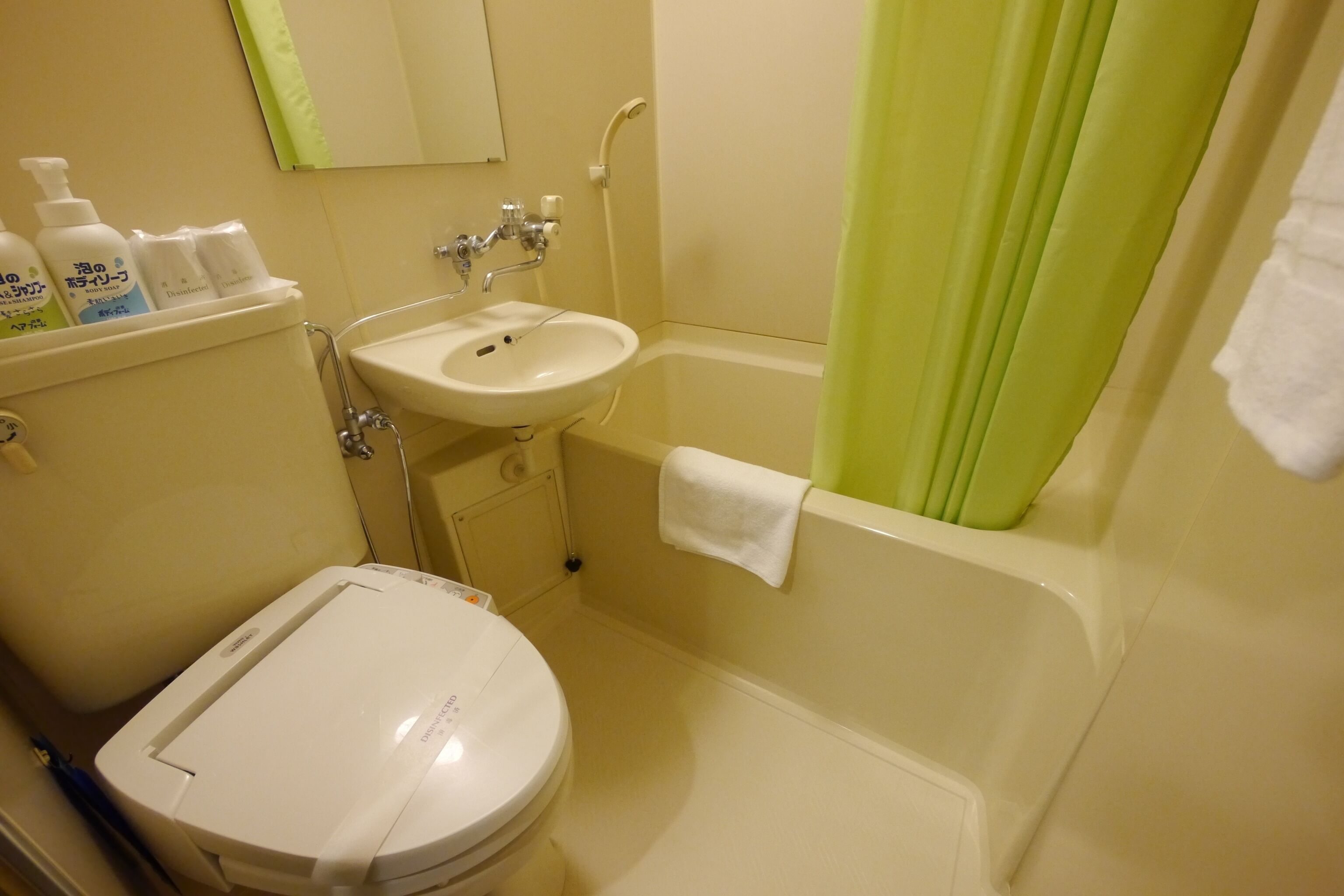A bathroom with a toilet, sink, and bathtub.