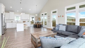A spacious living area with a gray sofa and a wooden coffee table. - 3 Bdr/3 Bth, King Bed, No Fees (Bolivar Peninsula)