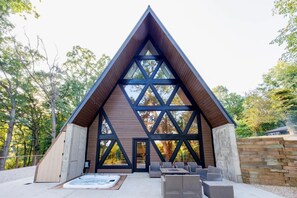 A modern building with a triangular roof and large windows. - Modern A-Frame Lake Cabin w/ Pickleball Ct.4Bd 3Ba (Genoa City)