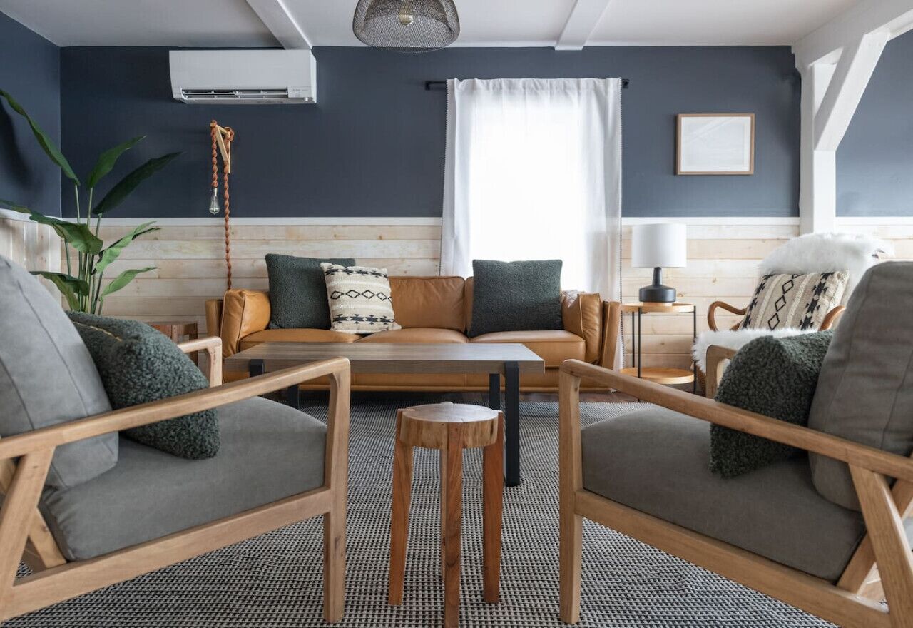 A cozy living room with a sofa, two armchairs, a coffee table, and a side table.