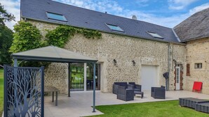 A stone building with a covered patio area, outdoor seating, and a garden. - Beautiful home in Rubercy with sauna (Rubercy)