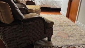 Une pièce chaleureuse avec un plafond en bois, un canapé, un lit et une petite table.