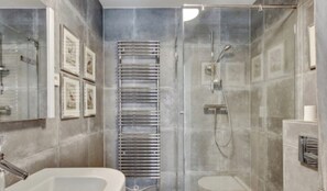 Enjoy a serene bathroom experience with a bathtub and separate shower area.