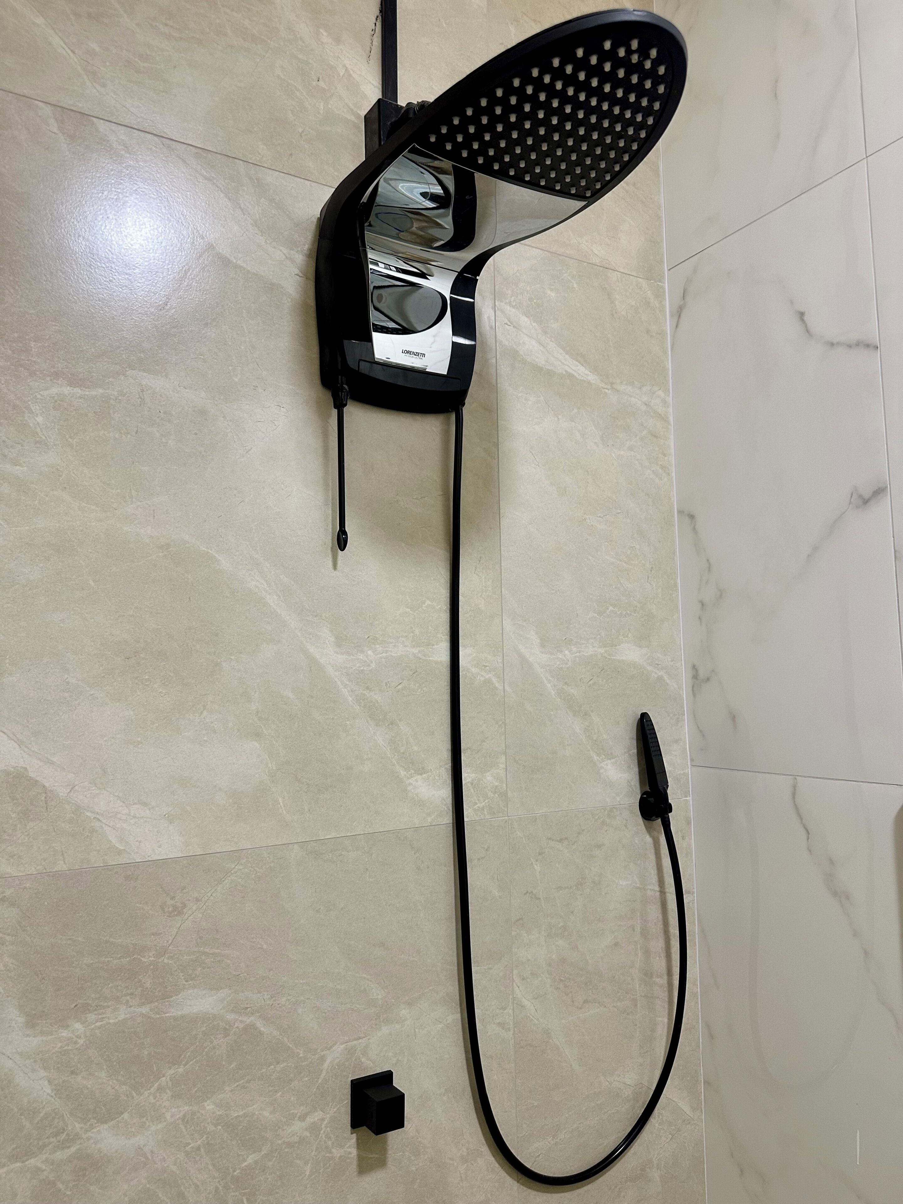 A hairdryer and a power strip on a tiled floor.