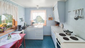 A compact kitchen with a sink, stove, and a window with curtains. - Beautiful home in Reksteren with WiFi (Reksteren)