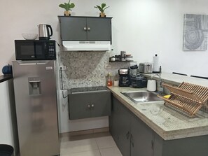 Fridge, microwave, stovetop, coffee/tea maker
