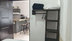 A compact room with a bunk bed, a small kitchenette, and a dining area. - cr.arenalapartments #1 beautiful, comfortable with parking (La Fortuna)