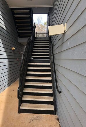 A staircase with a handrail leading to an upper level.