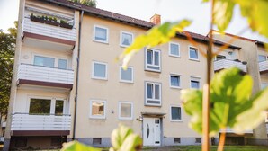 A multi-story residential building with balconies, a front door, and windows. - Be Home in Dortmund (Dortmund)