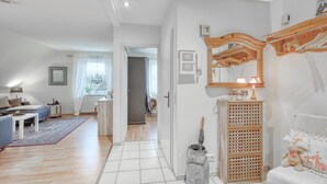 A spacious living room with a sofa, a coffee table, and a dining area. - Amazing apartment in Höhndorf with WiFi (Höhndorf)