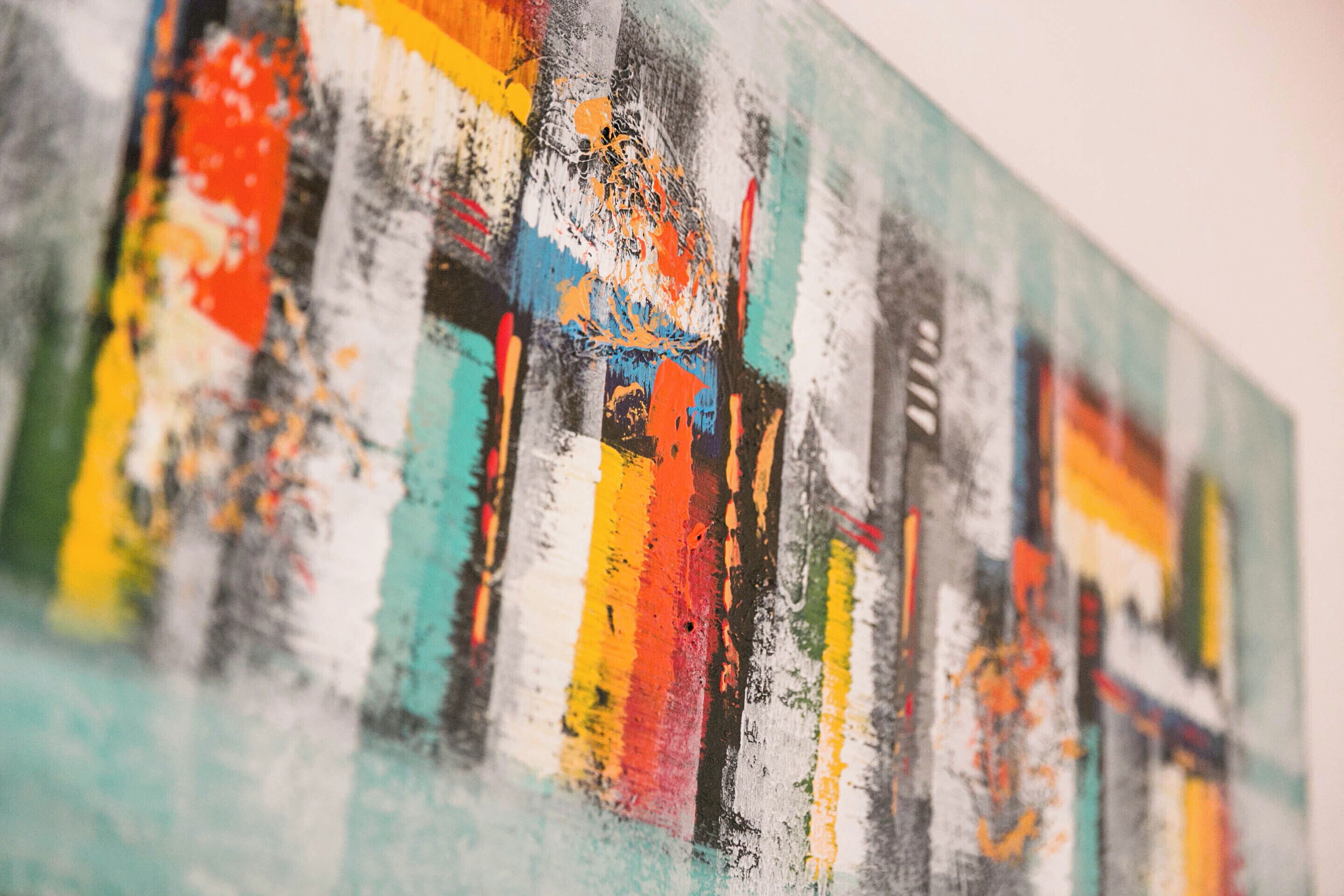 A close-up of a colorful abstract painting with vertical and horizontal lines.
