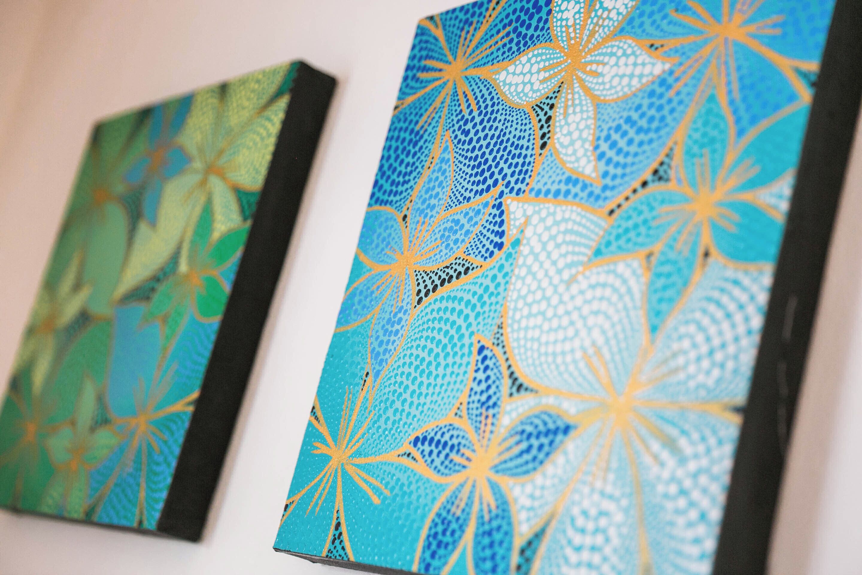 Two framed artworks with abstract floral patterns.