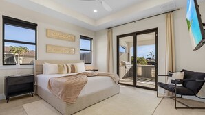 A bedroom with a bed, a nightstand, a chair, a ceiling fan, and a balcony with a view. - Modern 4-bed home with private heated pool, outdoor bar and grill in Cape Coral! (Cape Coral)