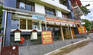 A building with signs advertising Hotel Maya, indicating rooms are available. - Fabhotel Maya (Dehradun)