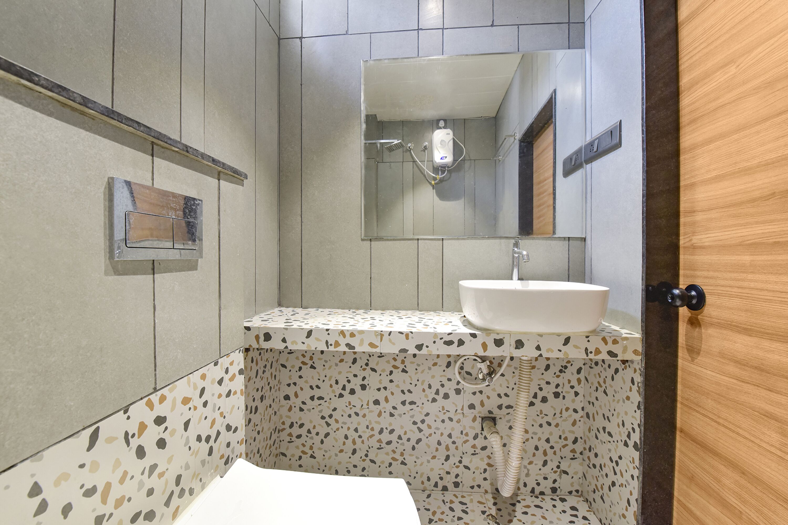 A bathroom with a white sink, a mirror, and a shower.