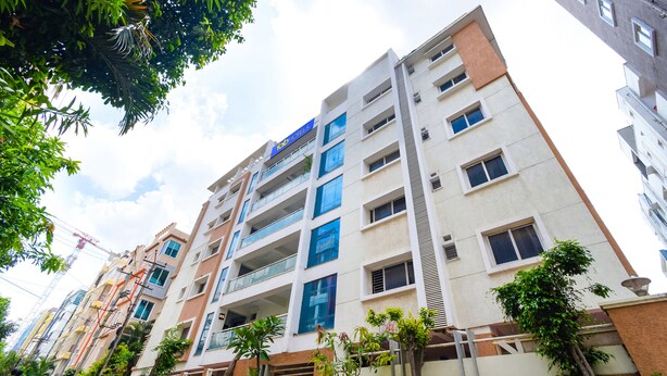 A multi-story building with balconies and a sign indicating it is a hotel. - Fabhotel Rs (Hyderabad)