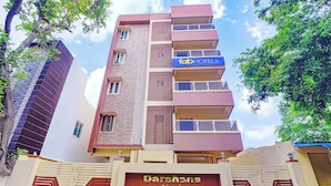 A multi-story building with a sign for 'Darshans Abode' at the entrance. - Fabhotel Darshan Adobe (Coimbatore)
