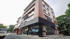 A multi-story hotel with a modern design, featuring a prominent sign for the hotel and a visible entrance. - Fabhotel Dream Inn (Bhopal)
