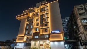 A modern hotel with multiple floors, a prominent entrance, and a sign indicating it is a Faber Hotel. - Fabhotel Well Back (Mumbai)
