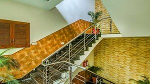 A staircase with a wooden finish and metal railings, leading to a lower level. - Fabhotel Aditya And Kings (Panchkula)