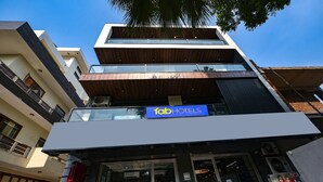 A multi-story building with a sign for 'fab hotels'. - Fabhotel The Grand Velvet (Noida)