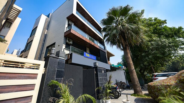 A modern hotel with a two-story structure, a visible sign for 'Tad Hotels', and a gated entrance. - Fabhotel The Grand Velvet (Noida)