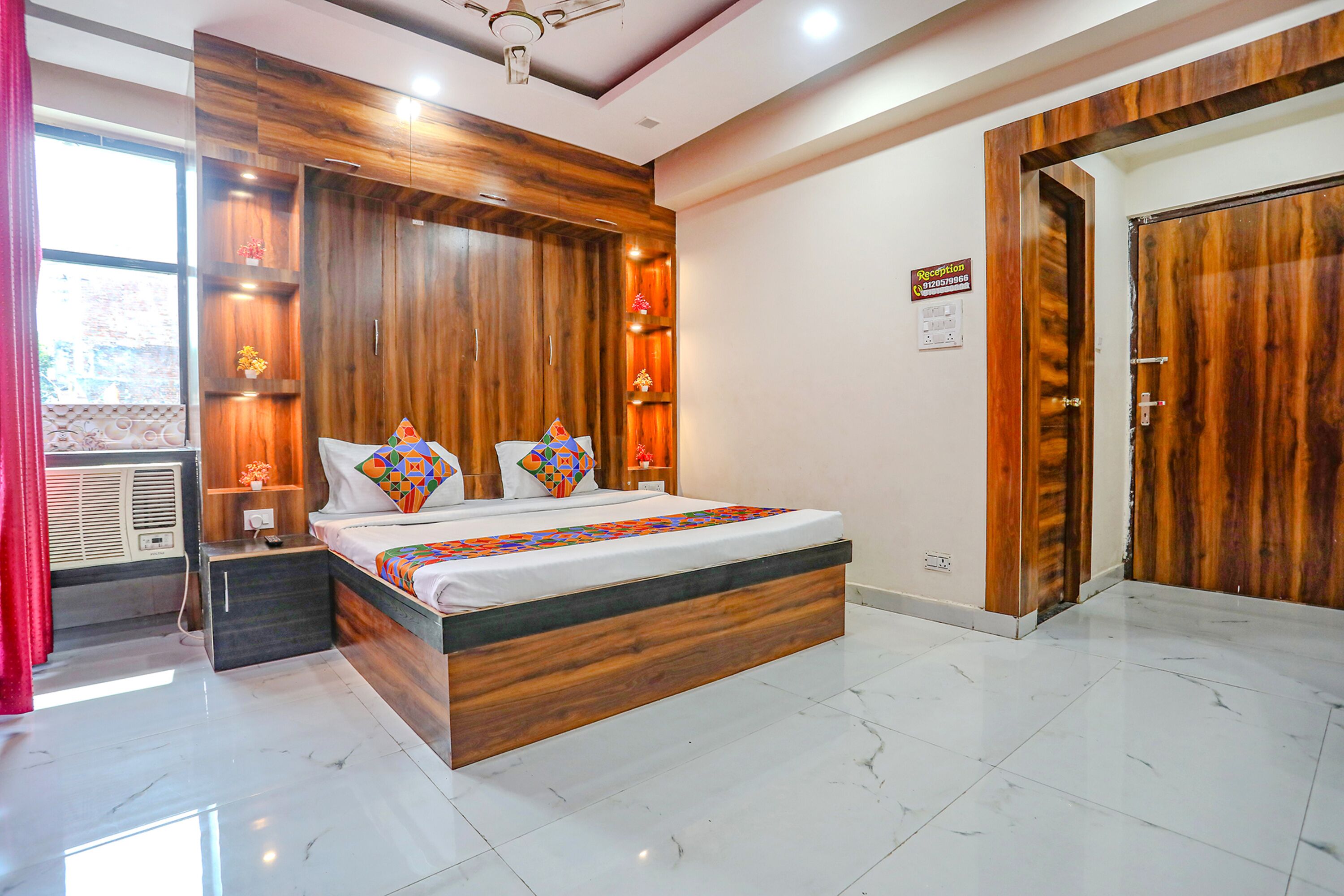 A modern bedroom with a wooden bed frame, a nightstand, and a built-in wardrobe.