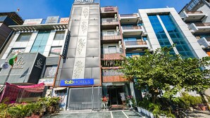 A multi-story hotel with a modern facade, balconies with railings, and a sign for 'Fatb Hotels'. - Fabhotel Prime Apple Tree Residency (New Delhi)