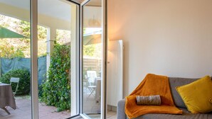 A modern living room with a grey sofa, a yellow throw blanket, and a yellow pillow. - Port Saint-Jacques by Interhome (La Bernerie-en Retz)