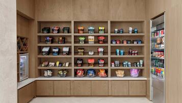 A well-organized pantry with various food items and beverages neatly arranged on shelves.