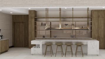 Una cocina moderna con encimera de mármol, taburetes de madera y estanterías empotradas.