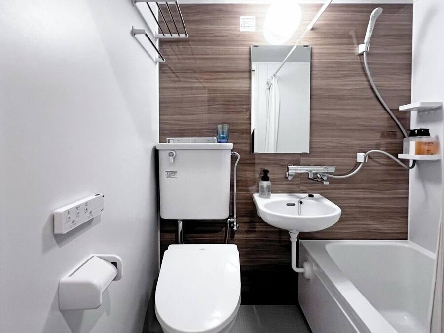 A compact bathroom with a toilet, sink, and bathtub.