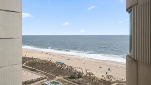 A beach view from a balcony with a clear sky. - Gorgeous 3 Bedroom Condo Oceanfront with Pool! (Ocean City)