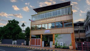 A Panakal Residency building with a two-story structure, a visible entrance, and a sign for CNS Maritime Services. - Panakal Residency (Kochi)