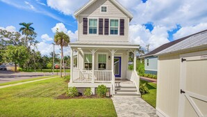 A two-story house with a porch, a garage, and a well-maintained lawn. - 1 Mi to Riverwalk: Brand New Bradenton Home (Bradenton)