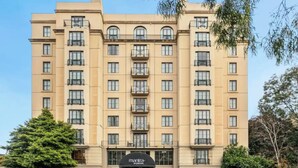 A multi-story hotel with a symmetrical facade, large windows, and a central entrance with a sign reading "Mantra." - Jolimont Views - Centrally located top floor apt overlooking MCG/Rod Laver (East Melbourne)