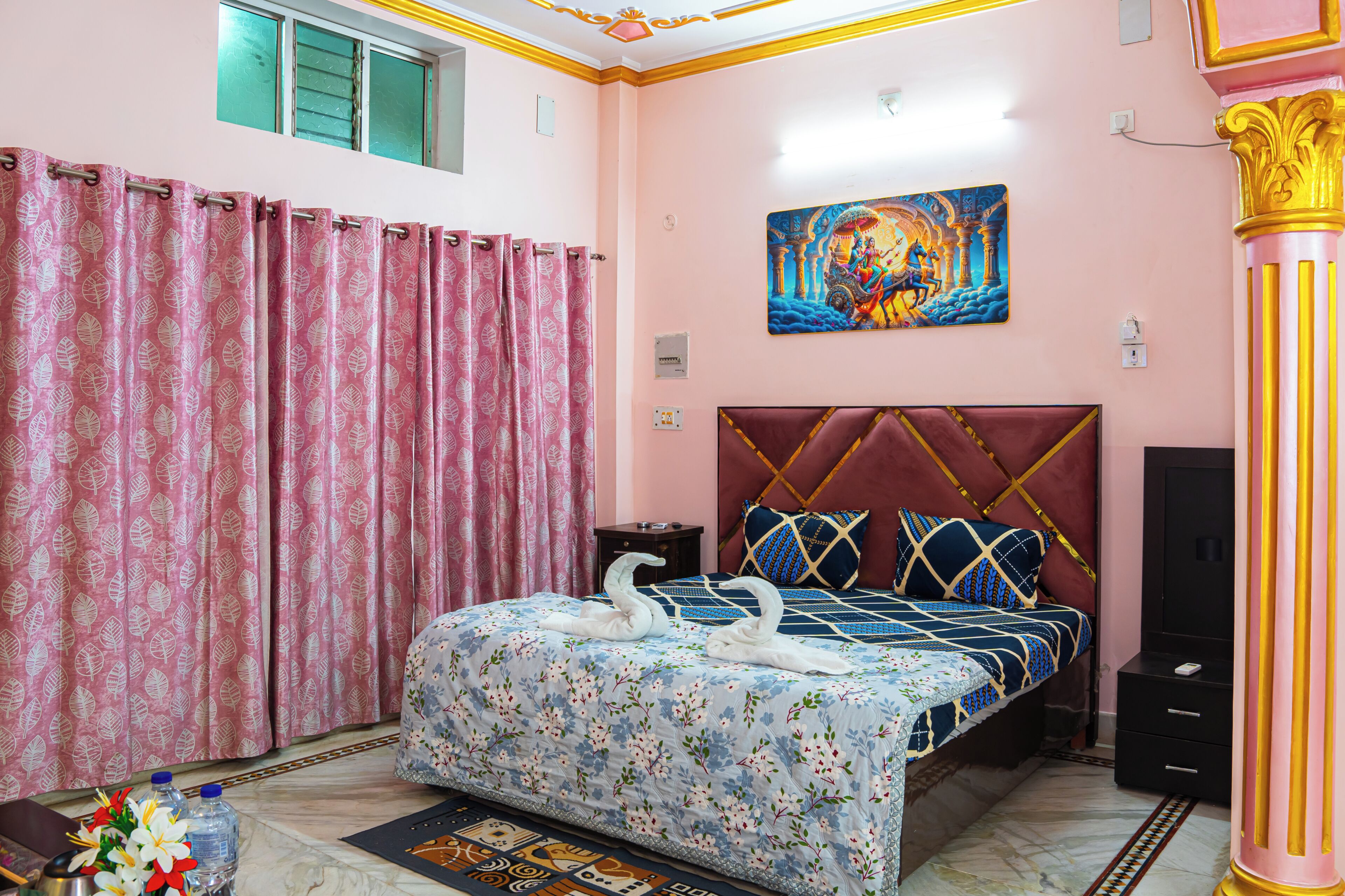 A bedroom with a bed, a wall painting, a window, and a curtain.