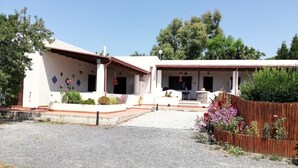 A two-story building with a gravel driveway and a wooden fence.
