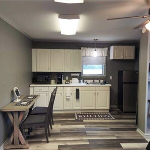 Fridge, microwave, coffee/tea maker, cookware/dishes/utensils