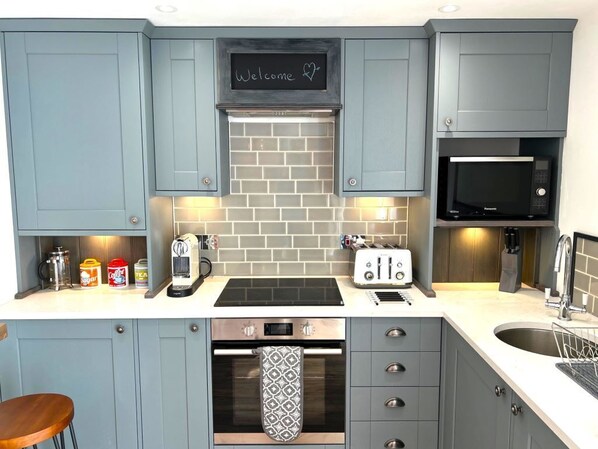Enjoy cooking and dining in this well-equipped kitchen with an oven, microwave, toaster, and coffee maker.