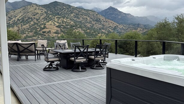 A deck with outdoor furniture and a hot tub, overlooking a mountainous landscape. - Beulah Land Only 4 Miles from SNP! (Three Rivers)