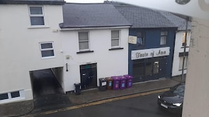 A building with a sign reading "Taste of Asia" and a black car parked in front.