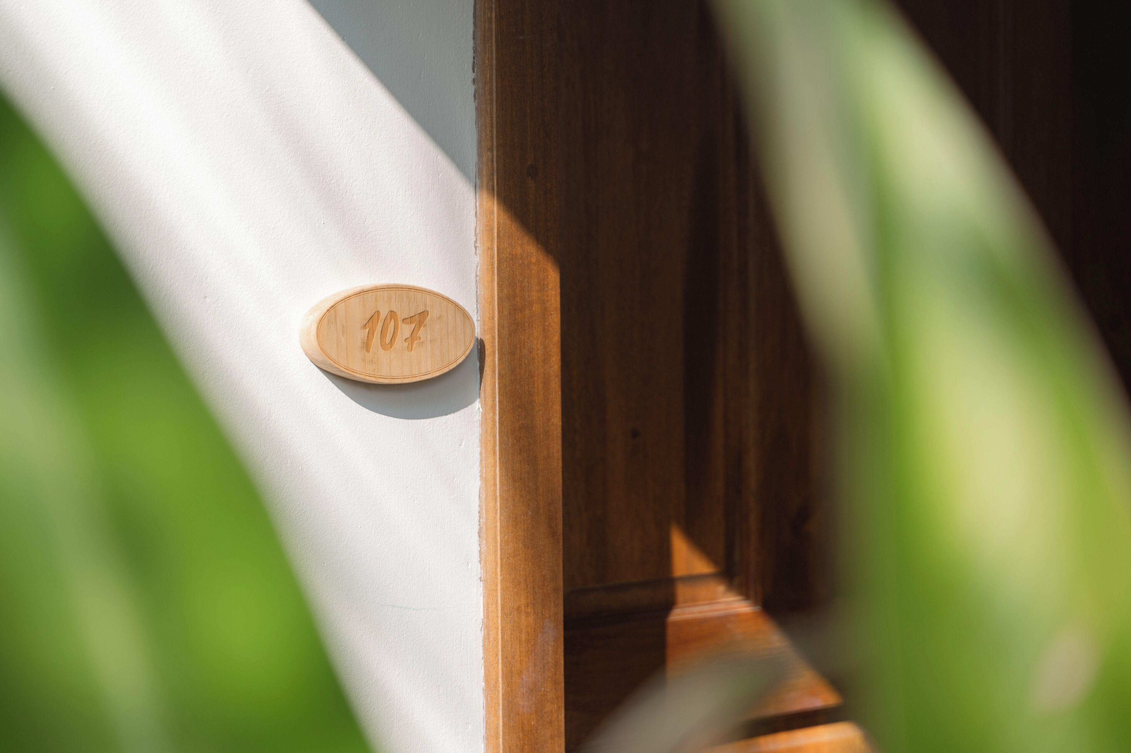 A wooden door with a number plaque.