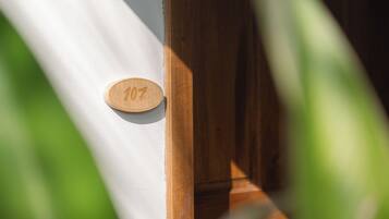 A wooden door with a number plaque.